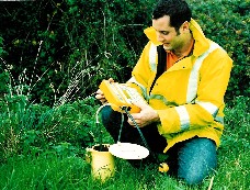 Image shows a technician carrying out landfill gas monitoring.