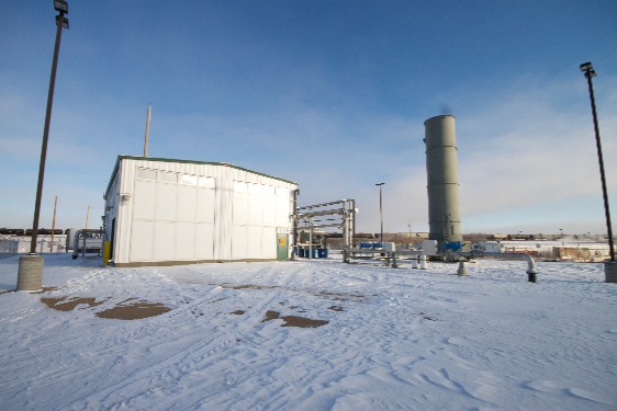 Image shows a landfill gas plant with an enclosed flare.