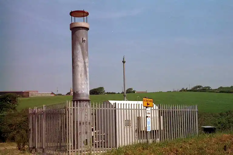 Landfill gas flare in a LFG extraction equipment compound.